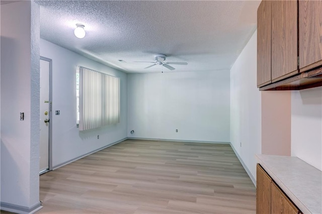 11321 W 77th Ter, Overland Park, KS 66214 - unfurnished dining area featuring a ceiling fan, light wood-style floors, and a textured ceiling