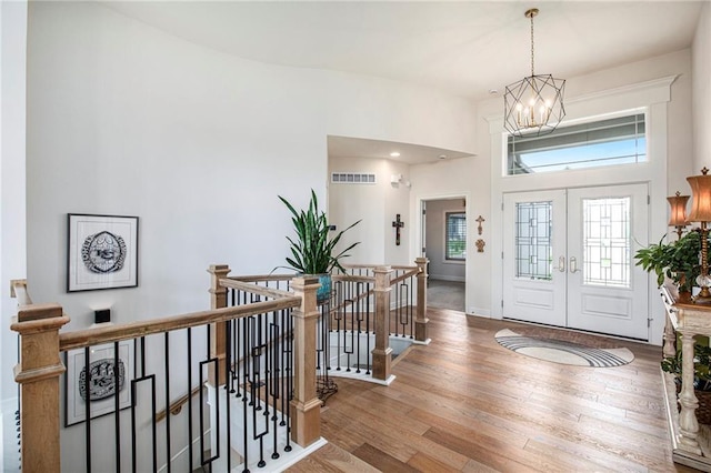 130 NW Ambersham Dr, Lees Summit, MO 64081 - entryway with wood finished floors, a chandelier, and french doors