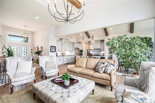 130 NW Ambersham Dr, Lees Summit, MO 64081 - living room featuring a chandelier, light wood finished floors, beam ceiling, recessed lighting, and high vaulted ceiling
