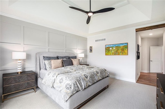 130 NW Ambersham Dr, Lees Summit, MO 64081 - bedroom with carpet flooring, a tray ceiling, a decorative wall, ornamental molding, and a ceiling fan