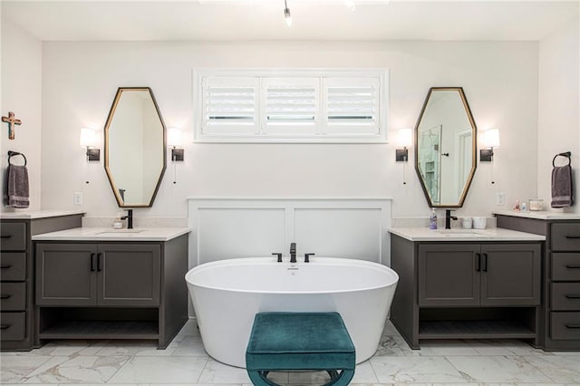 130 NW Ambersham Dr, Lees Summit, MO 64081 - full bath with marble look tile flooring, two vanities, and a freestanding bath