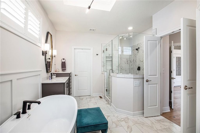 130 NW Ambersham Dr, Lees Summit, MO 64081 - bathroom featuring marble look tile flooring, a stall shower, a freestanding bath, vanity, and healthy amount of natural light