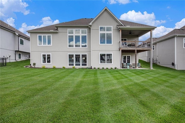 130 NW Ambersham Dr, Lees Summit, MO 64081 - rear view of house with a ceiling fan, a lawn, a balcony, and a patio area