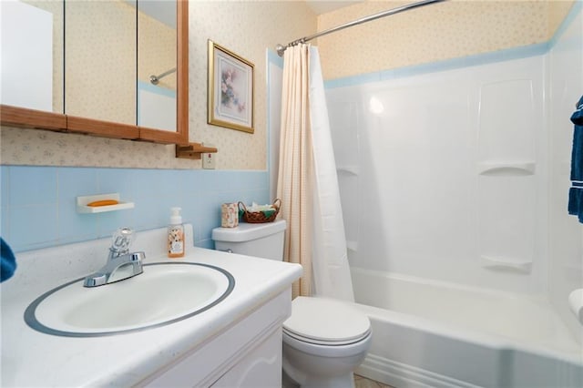 9643 Y Rd, Meriden, KS 66512 - full bathroom with wallpapered walls, vanity, a wainscoted wall, shower / tub combo with curtain, and tile walls