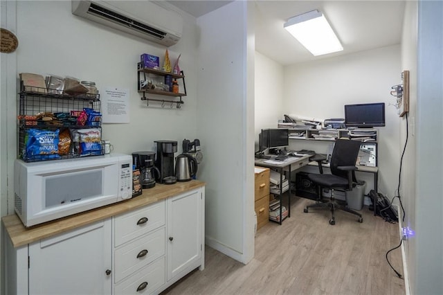 9643 Y Rd, Meriden, KS 66512 - office space featuring a wall mounted air conditioner and light wood-style flooring