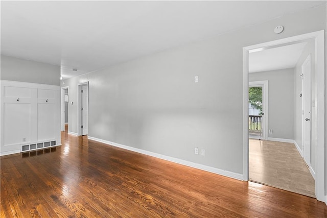4510 E 113th St, Kansas City, MO 64137 - unfurnished living room featuring wood finished floors and baseboards
