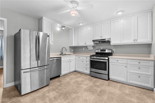 4510 E 113th St, Kansas City, MO 64137 - kitchen with stainless steel appliances, under cabinet range hood, light countertops, and white cabinetry