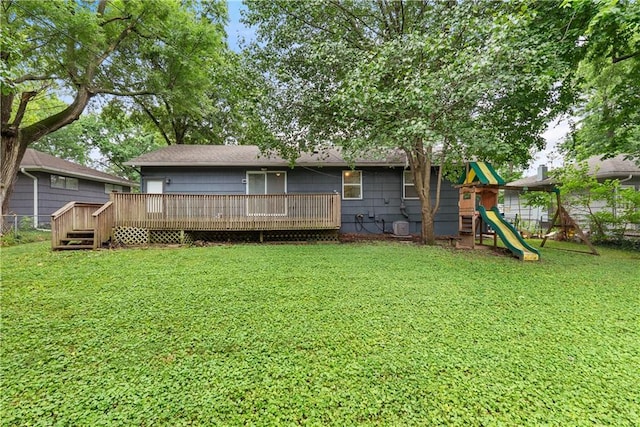 4510 E 113th St, Kansas City, MO 64137 - back of property with a playground and a deck