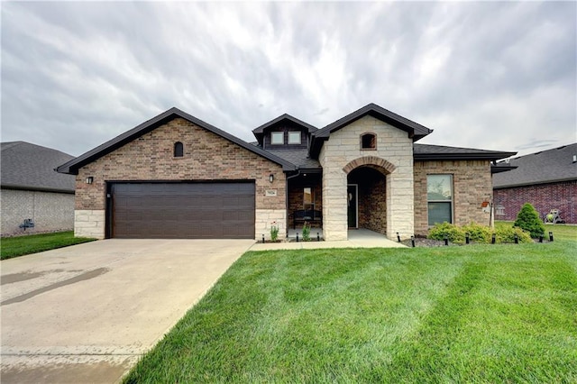 7526 Apache Dr, Lenexa, KS 66227 - french provincial home featuring driveway, a front yard, an attached garage, stone siding, and brick siding