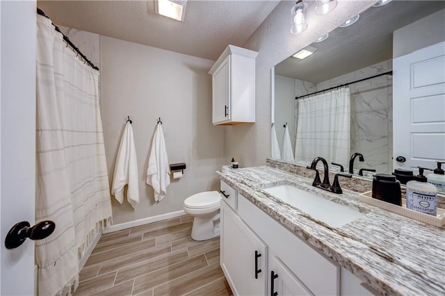 7526 Apache Dr, Lenexa, KS 66227 - bathroom featuring vanity, wood tiled floors, a textured ceiling, and a shower with curtain