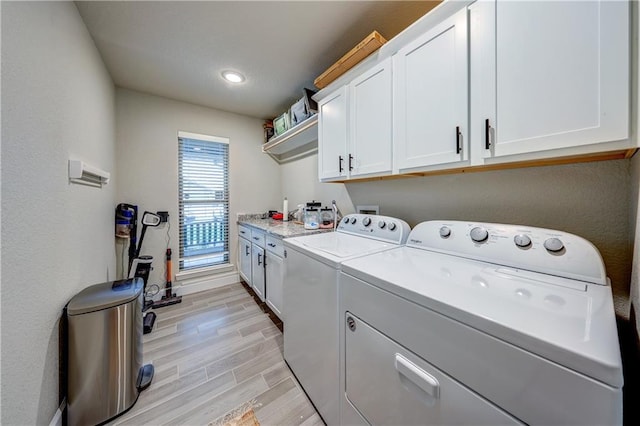 7526 Apache Dr, Lenexa, KS 66227 - laundry room with cabinet space, washing machine and clothes dryer, light wood-type flooring, and recessed lighting