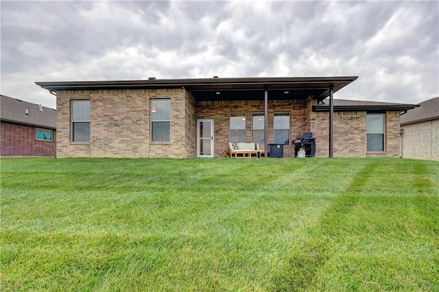 7526 Apache Dr, Lenexa, KS 66227 - rear view of house featuring a lawn and brick siding