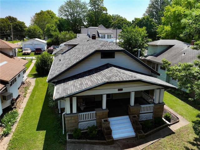 1208 Central Ave, Horton, KS 66439 - view of front facade featuring a porch, roof with shingles, stone siding, and a front yard
