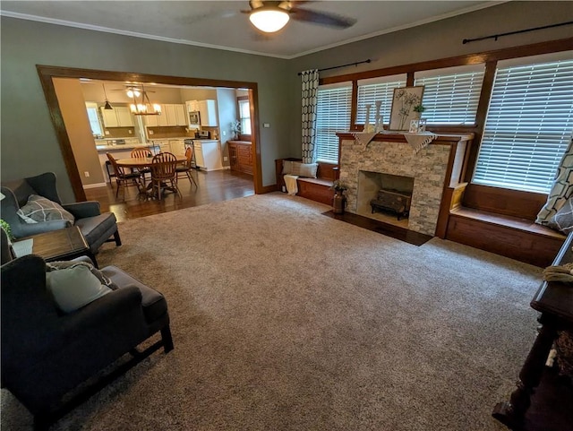 1208 Central Ave, Horton, KS 66439 - living room featuring crown molding, a ceiling fan, a fireplace, and carpet flooring