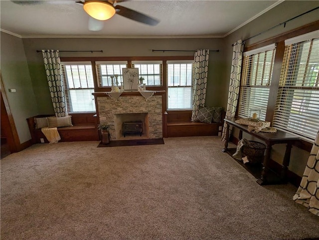1208 Central Ave, Horton, KS 66439 - carpeted living room with ornamental molding, ceiling fan, and a stone fireplace
