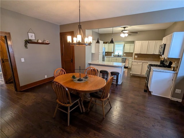 1208 Central Ave, Horton, KS 66439 - dining room featuring a chandelier, dark wood finished floors, and a ceiling fan