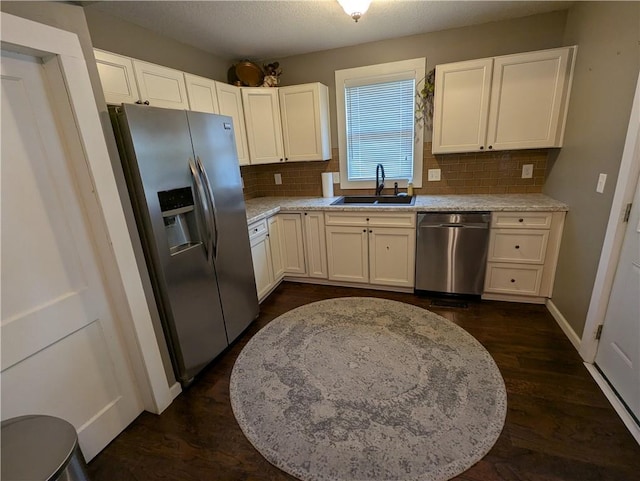1208 Central Ave, Horton, KS 66439 - kitchen with stainless steel appliances, decorative backsplash, white cabinetry, and dark wood-type flooring