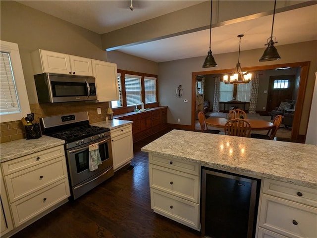 1208 Central Ave, Horton, KS 66439 - kitchen with stainless steel appliances, wine cooler, a chandelier, plenty of natural light, and beamed ceiling