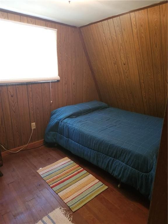 23664 Erickson Ln, Wheatland, MO 65779 - bedroom with wood finished floors and wood walls