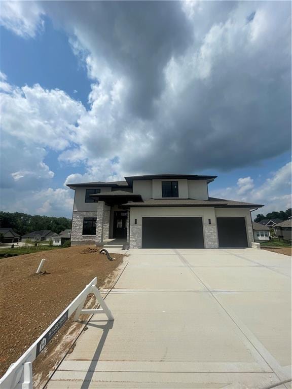 1824 Arbor Trl, Liberty, MO 64068 - prairie-style home featuring driveway, stone siding, a garage, and stucco siding