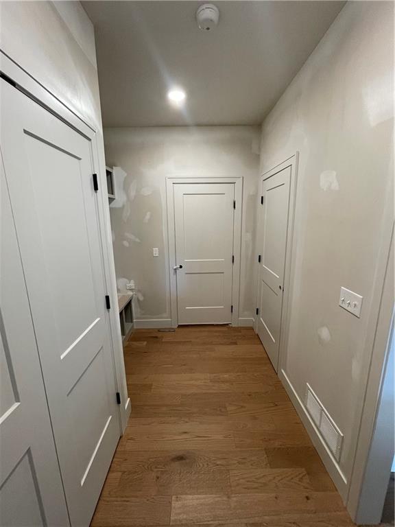 1824 Arbor Trl, Liberty, MO 64068 - corridor with light wood finished floors and recessed lighting