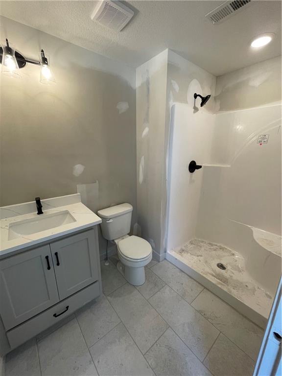 1824 Arbor Trl, Liberty, MO 64068 - full bath with a shower stall, vanity, and a textured ceiling
