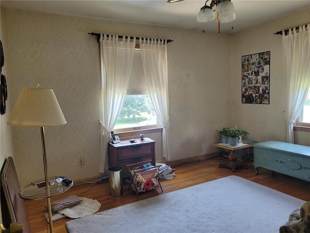 8603 E 85th St, Raytown, MO 64138 - living area featuring wood finished floors, ceiling fan, and wallpapered walls