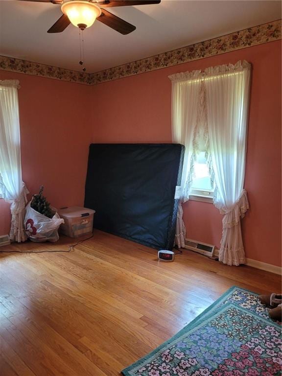 8603 E 85th St, Raytown, MO 64138 - unfurnished bedroom featuring wood finished floors and ceiling fan
