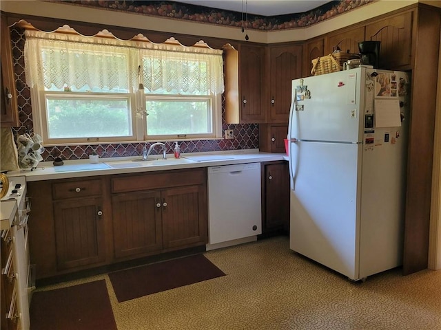 8603 E 85th St, Raytown, MO 64138 - kitchen featuring white appliances, tasteful backsplash, and light countertops