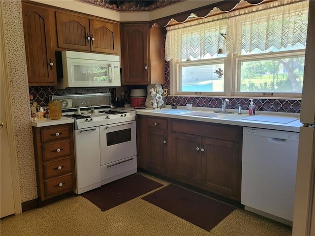 8603 E 85th St, Raytown, MO 64138 - kitchen with white appliances, light countertops, and backsplash