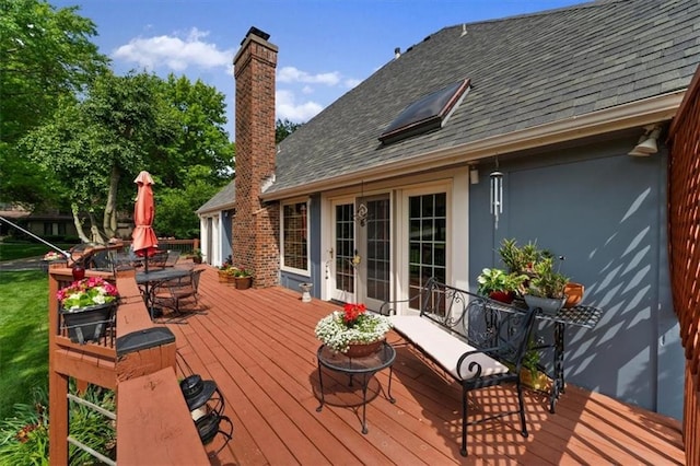 12600 Wenonga Ln, Leawood, KS 66209 - wooden deck with outdoor dining area and french doors