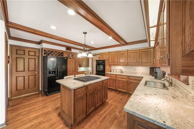 12600 Wenonga Ln, Leawood, KS 66209 - kitchen featuring black appliances, a kitchen island, brown cabinets, light stone countertops, and light wood-type flooring
