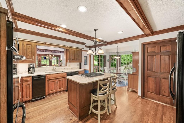 12600 Wenonga Ln, Leawood, KS 66209 - kitchen with a textured ceiling, refrigerator, a kitchen island, light wood finished floors, and brown cabinetry