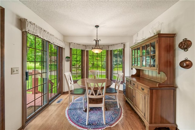 12600 Wenonga Ln, Leawood, KS 66209 - dining space featuring a textured ceiling and light wood-style floors