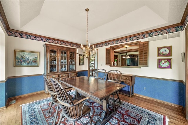 12600 Wenonga Ln, Leawood, KS 66209 - dining space featuring a chandelier, wood finished floors, and a raised ceiling