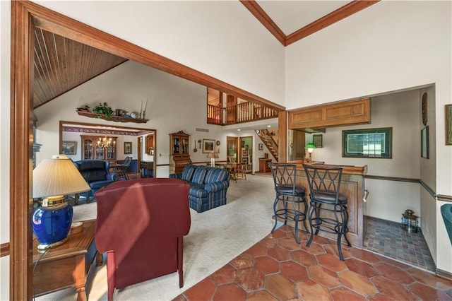 12600 Wenonga Ln, Leawood, KS 66209 - tiled living room with a bar, stairway, high vaulted ceiling, carpet floors, and ornamental molding