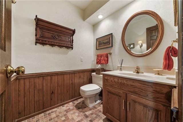 12600 Wenonga Ln, Leawood, KS 66209 - half bathroom with vanity, wainscoting, and wooden walls
