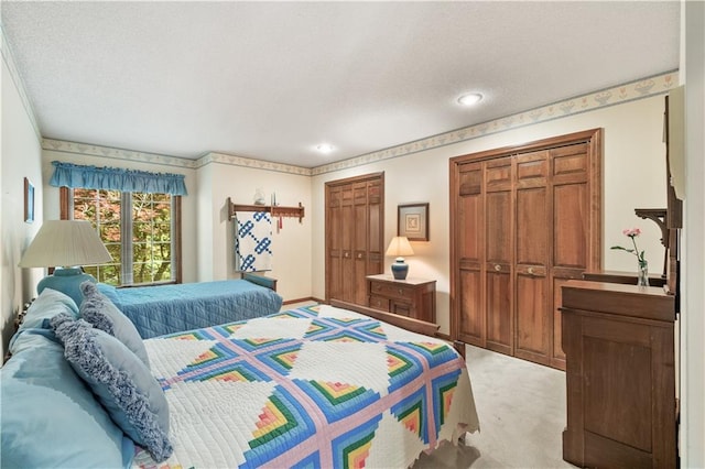 12600 Wenonga Ln, Leawood, KS 66209 - bedroom featuring multiple closets, light colored carpet, recessed lighting, and a textured ceiling