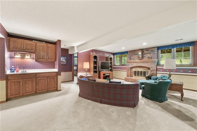 12600 Wenonga Ln, Leawood, KS 66209 - living area with light colored carpet, a fireplace, and a textured ceiling