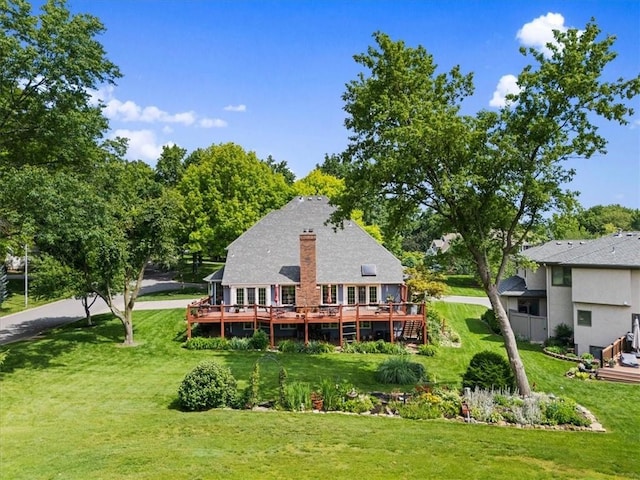 12600 Wenonga Ln, Leawood, KS 66209 - rear view of house with a wooden deck, a lawn, and a chimney