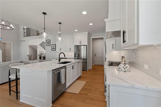 7106 Linden St, Prairie Village, KS 66208 - kitchen with stainless steel appliances, open floor plan, tasteful backsplash, white cabinets, and recessed lighting