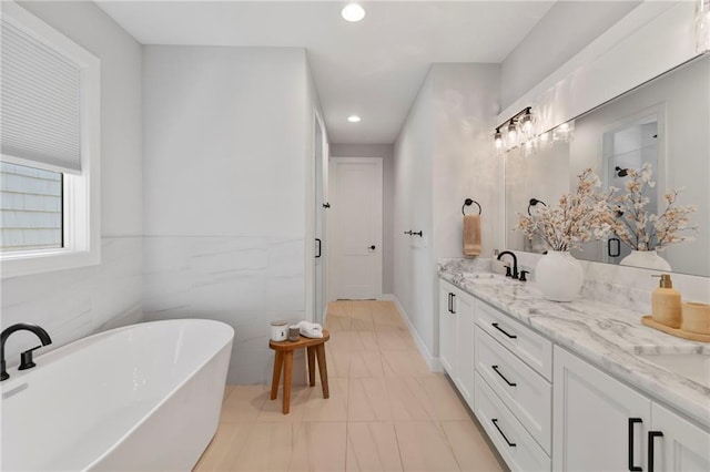7106 Linden St, Prairie Village, KS 66208 - bathroom featuring a freestanding bath, double vanity, recessed lighting, and tile patterned flooring