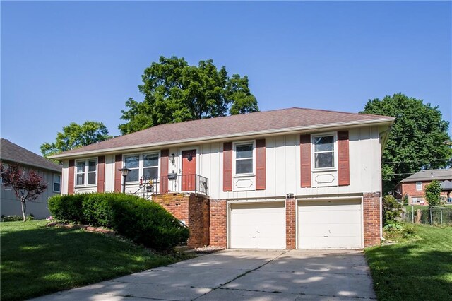 3920 S Milton Dr, Independence, MO 64055 - view of front of house featuring brick siding, driveway, an attached garage, and a front lawn