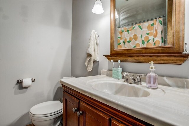 3920 S Milton Dr, Independence, MO 64055 - full bathroom with vanity, toilet, and a shower with shower curtain