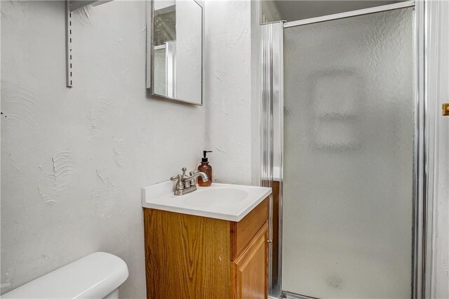 3920 S Milton Dr, Independence, MO 64055 - full bathroom featuring vanity, a stall shower, and toilet
