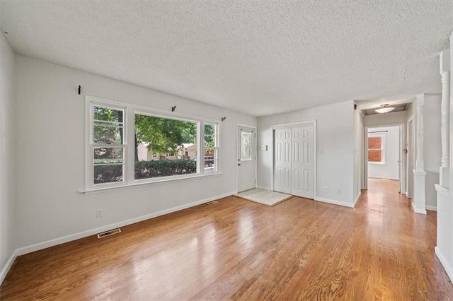 1822 Rankin Dr, Independence, MO 64055 - unfurnished bedroom with light wood-type flooring, a textured ceiling, and a closet
