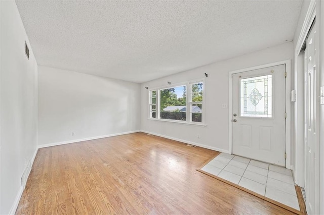 1822 Rankin Dr, Independence, MO 64055 - entrance foyer featuring light wood-type flooring and a textured ceiling