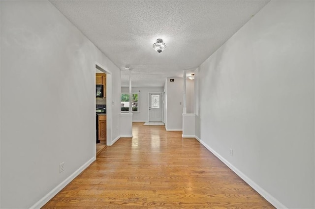 1822 Rankin Dr, Independence, MO 64055 - hallway with a textured ceiling and light wood-type flooring