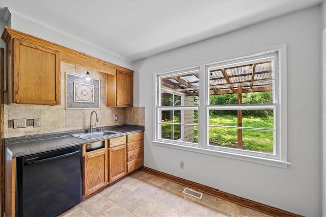 1822 Rankin Dr, Independence, MO 64055 - kitchen with black dishwasher, backsplash, dark countertops, and brown cabinets