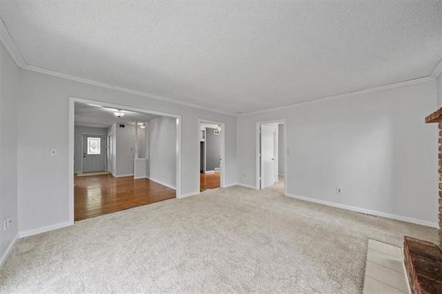 1822 Rankin Dr, Independence, MO 64055 - unfurnished living room with carpet flooring, a textured ceiling, and ornamental molding